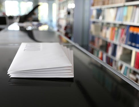 White envelope stack in office